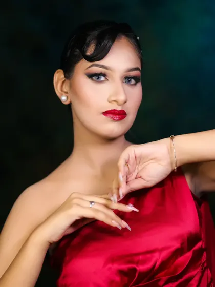 This portrait showcases a complete party-ready look, from the sleek hair to the polished makeup and nails.