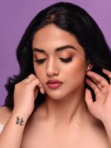 This close-up beauty shot is all about the eyes. The soft lighting and the model's expression create a gentle and captivating portrait, perfect for showcasing subtle makeup looks.