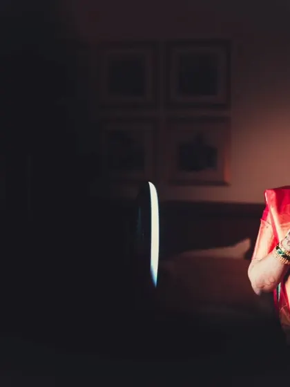 A creative portrait of the bride, using dramatic lighting to create a moody and beautiful image as she gets ready.