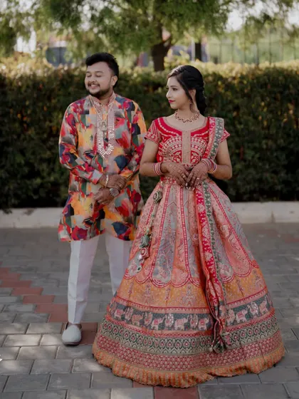 A colorful and happy portrait of the couple in their vibrant Sangeet outfits.