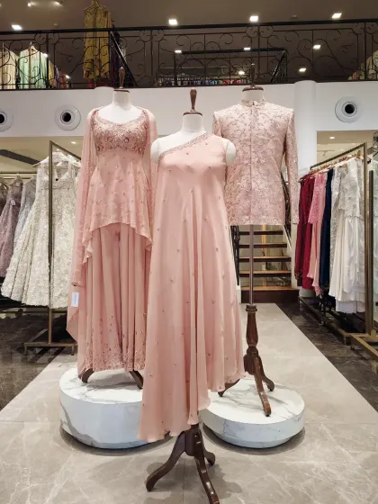 Soft pastels are a refined choice for daytime ceremonies. This blush pink sherwani on display features delicate embroidery, demonstrating a softer approach to groom's wear.