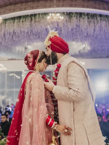 A tender forehead kiss, capturing the love and emotion of the wedding ceremony.