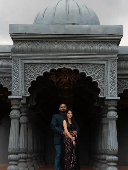 A powerful, regal shot of the couple. The makeup is designed to look flawless even in wide, architectural shots.