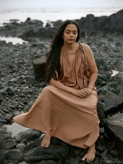 A portrait of my dear friend, a fellow photographer, against a rocky beach. The earthy tones and raw texture of the location perfectly match her free-spirited energy.
