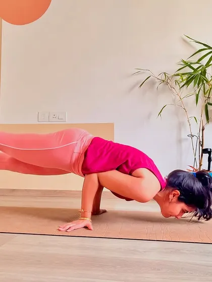 A moment of hang time in Mayurasana. This shows that with repeated practice, the body starts to understand the mechanics of the pose, and you find moments of success, no matter how brief.