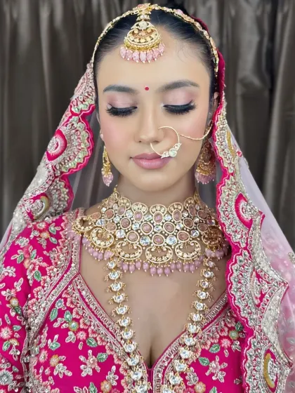 The full look with the dupatta. The soft pink makeup perfectly complements her vibrant pink lehenga.
