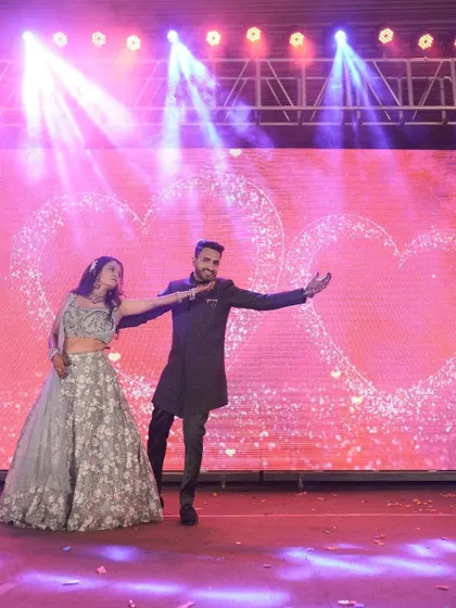 A beautiful shot from a romantic couple's duet against a backdrop of glittering hearts. We work with you to select the perfect song and style that captures the essence of your relationship for your sangeet dance.