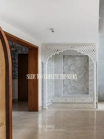 This image shows the view from the entryway, where a rattan and wood arch perfectly frames the stunning marble mandir, creating a sense of harmony and flow from the moment you enter.