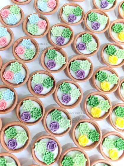 A colorful batch of succulent clay pot candles, made as eco-friendly return gifts for a housewarming ceremony.