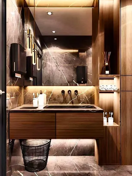 A luxurious powder room with dark marble walls and rich wood textures. The floating vanity, backlit mirror, and elegant pendant lights create a sophisticated and high-end look.