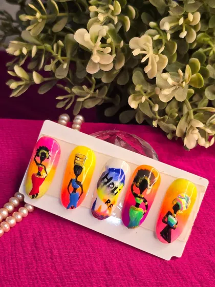 A vibrant and artistic set of nails featuring African tribal-inspired silhouettes against a colorful ombre background. This showcases the creative potential of freehand painting.