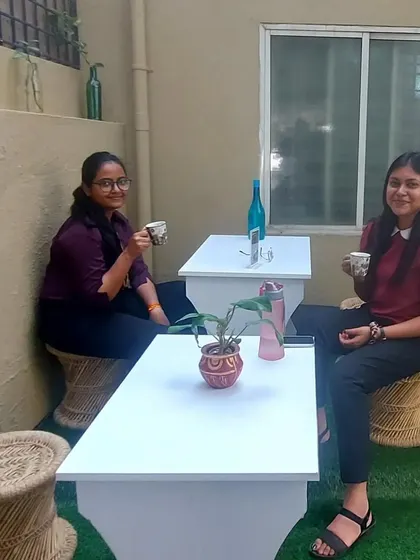 Customers enjoying a cup of our special Maska Chai in the cozy outdoor seating area of our cafe. It's a great spot to relax and catch up with friends.