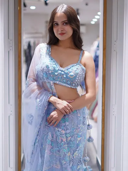 A closer look at the beautifully embellished blouse of the celestial blue fish-tail lehenga. The craftsmanship is designed to make you feel like you're wearing a piece of art.