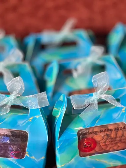 A closer look at the custom-labeled favor boxes. The label "Parivar Milan 2024" shows how I can personalize gifts for any family gathering or event.