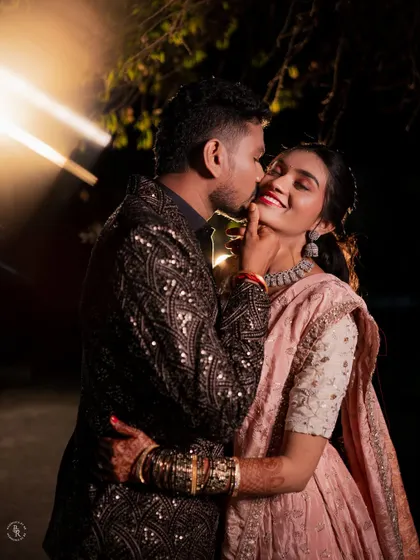 An intimate and playful moment between the couple after their Sangeet performance, captured with creative lighting.