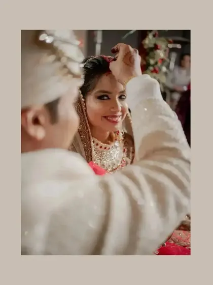 A close-up of the sindoor ceremony, a deeply significant and emotional moment for the couple.