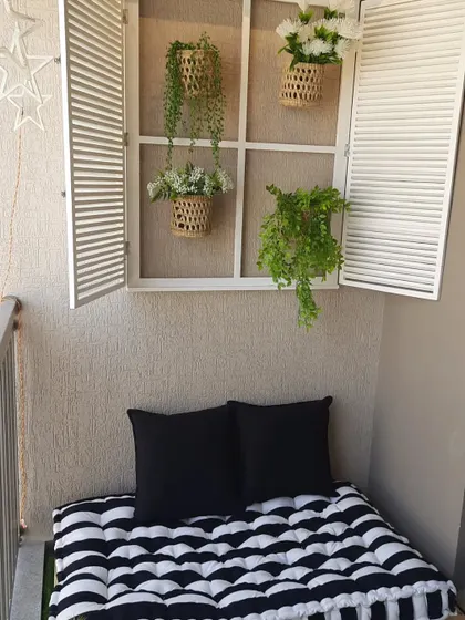 A cosy reading nook is a dream for so many. I created this peaceful corner using a low wooden pallet bench with a comfy striped mattress and a decorative French window to add a touch of architectural charm to a plain wall.