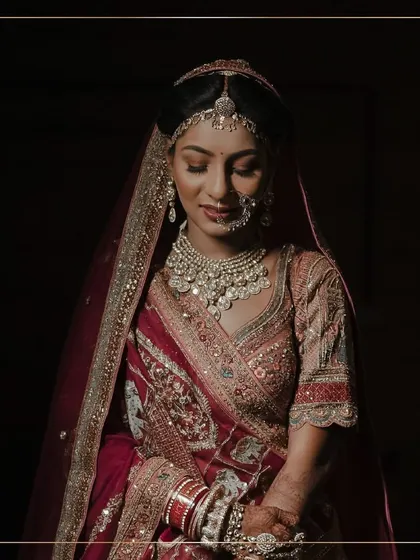 A beautifully lit portrait of the bride. Her makeup is kept soft and elegant, allowing the intricate details of her jewellery and lehenga to shine.