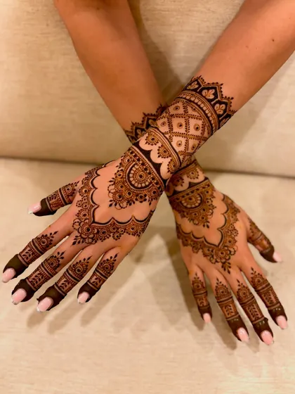 A beautiful and dense engagement mehendi with scalloped borders, detailed mandalas, and fine line work for a rich, full look.
