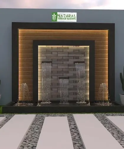 A modern wall fountain design with a stone-clad surface. The water flows gently over the textured stone, creating a soothing sound and visual effect.