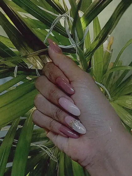 A stylish multi-tonal look using shades of mauve and pink, with a single glitter and rhinestone accent nail.