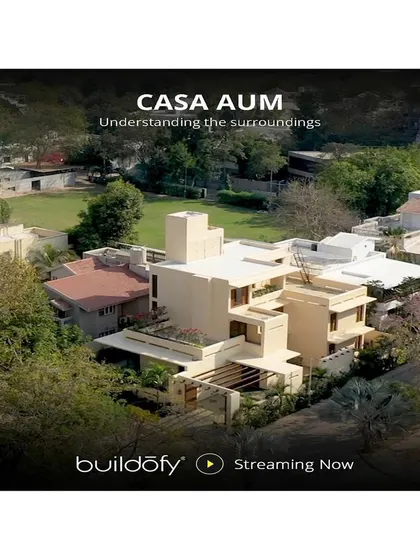 An aerial view shows how Casa AUM is situated within its surroundings, designed to maximize privacy while still connecting with the neighborhood's green spaces.