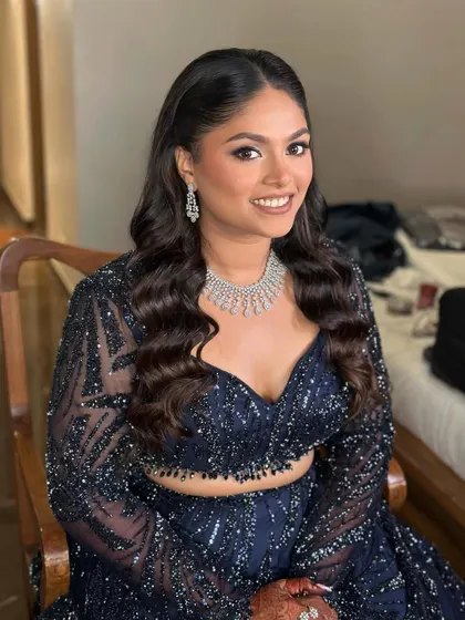 A happy bride ready for her Sangeet. The creative, trendy makeup gives her a confident and radiant look.