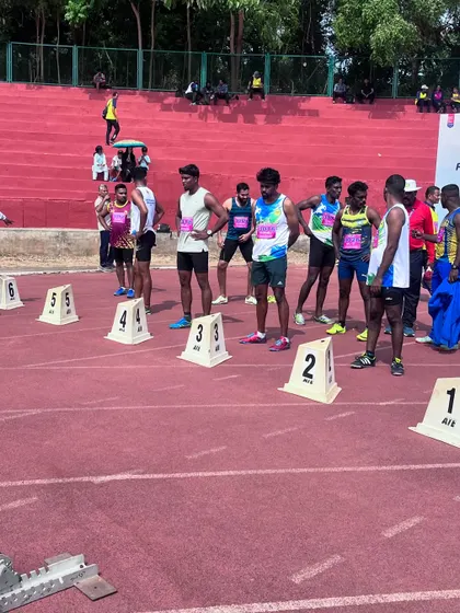 The starting line of a sprint final. This is the moment of intense focus before the race, where all the training comes down to a few seconds of explosive effort.