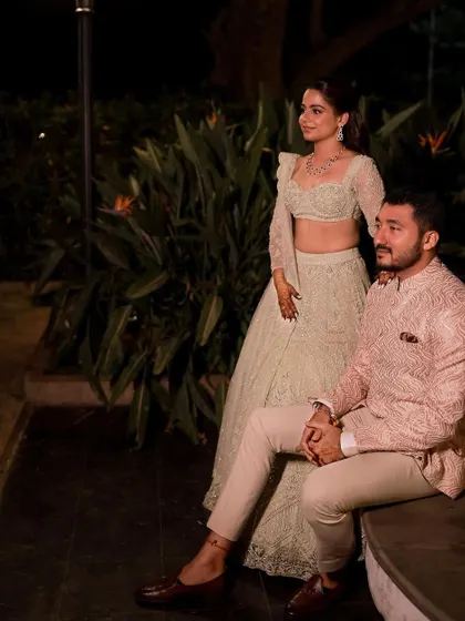 A stunning couple portrait from a Sangeet, where the makeup provides a minimalistic yet luminous glow that looks beautiful in professional photos.