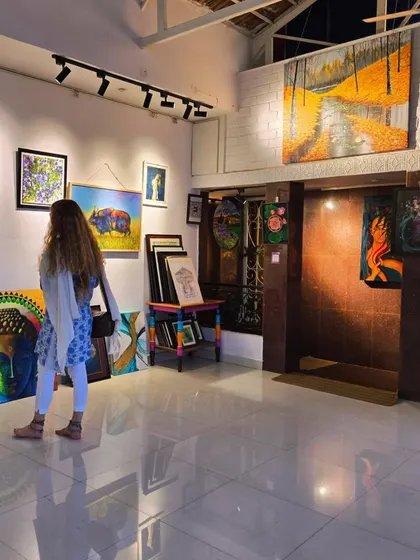 A visitor browses our multi-artist affordable art exhibition. Our gallery is a treasure trove of unique pieces, with something for every taste and budget.