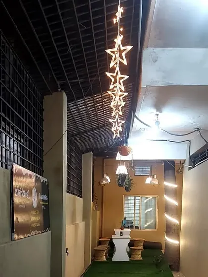 The cozy and well-lit ambiance of our cafe in the evening. The star lights and warm decor make it a perfect place to unwind with a cup of chai and snacks.