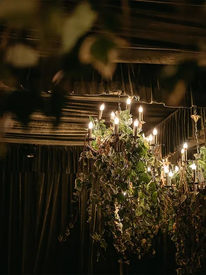 A ceiling of pristine white petals and hanging chandeliers, transforming the night into a haven of timeless beauty.