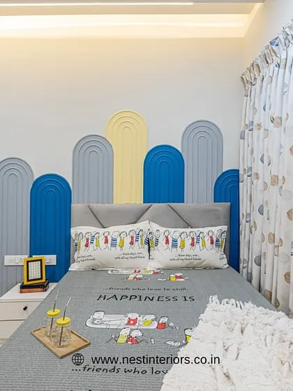 Another view of the kid's bedroom, showing the playful headboard design and the matching curtains. Creating a thematic look makes the room feel special and well-designed.