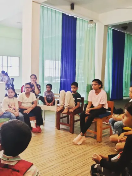 A candid shot of the audience during a story circle for older kids. You can see them listening intently, fully immersed in the narrative we are building together.