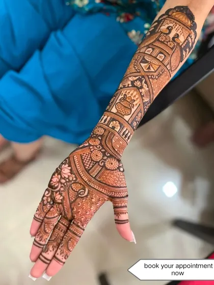 This design showcases a variety of traditional elements, including a doli scene, a kalash, and peacocks, all on one arm.