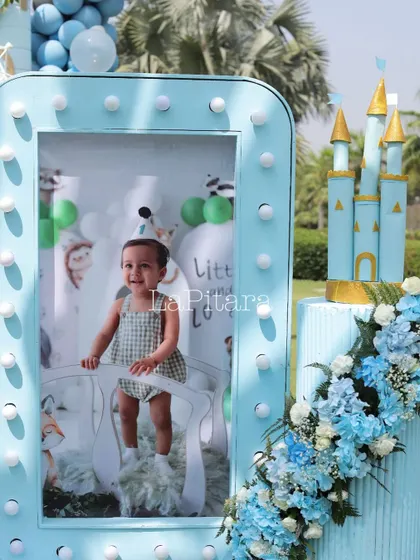 Another personalized photo frame, this one placed next to a miniature castle cake, showcasing the blend of personal touches and thematic decor.