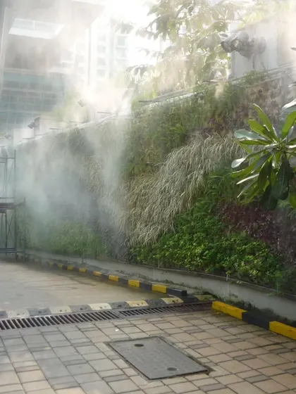 Here is a vertical garden we maintain, with its integrated misting system in action. Proper irrigation is critical for the health of a green wall, and our team ensures these technical systems are always functioning perfectly to keep the foliage dense and vibrant.