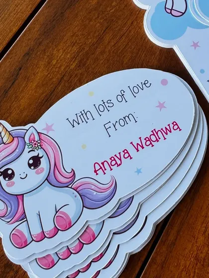 A close-up on our sweet sitting unicorn gift tag, showing the high-quality printing and custom shape.
