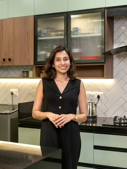 My client Akshata in her 'Bohemian Bliss' kitchen. She and her husband trusted us completely, which allowed us to create a home that was a true amalgamation of design and convenience.