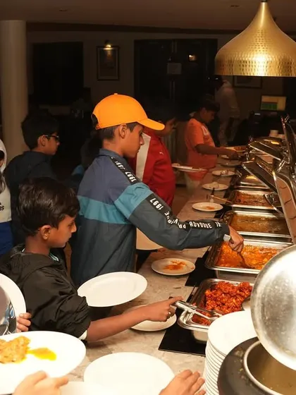 Team mealtime in Ooty. Traveling together teaches players independence and responsibility.