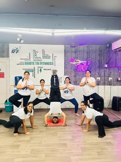 This is what support looks like. A member confidently holds a Sirsasana or headstand, surrounded and encouraged by her yoga sisters during our International Yoga Day session. We ensure you feel safe attempting advanced poses.