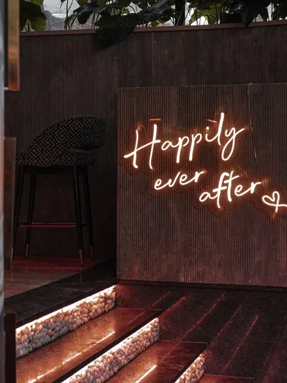 A 'Happily ever after' neon sign adds a modern and romantic touch to the Mehendi decor. It’s a perfect photo opportunity for the couple and their guests.