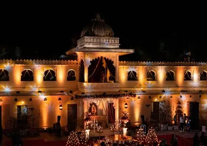 A historic palace in Udaipur illuminated for an evening wedding event. Our technical teams use lighting to highlight the architectural beauty and create a warm, inviting atmosphere.