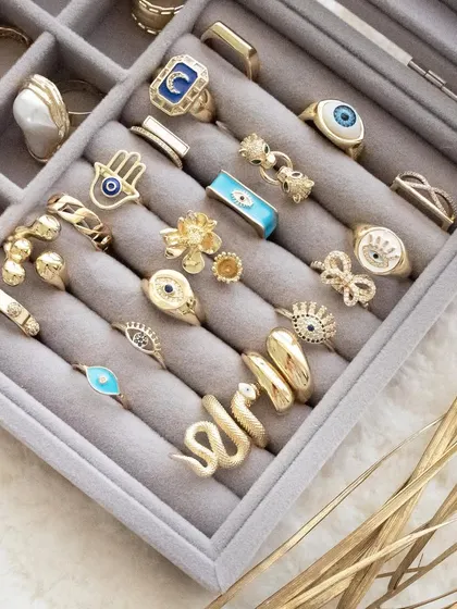 Build your ring stack. This image shows a tray full of my evil eye, hamsa, and other statement rings.