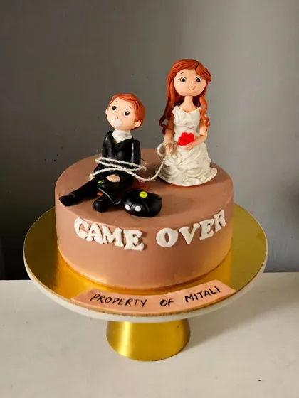 The full view of the "Game Over" bachelorette cake, a fun and memorable centerpiece for a pre-wedding celebration.