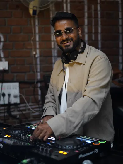 A clear shot of me at the decks, focused and enjoying the moment. This shows my professional setup and my hands-on approach to live mixing, ensuring the music flows perfectly throughout your event.