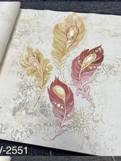 A wallpaper sample with a design of red and gold jeweled peacock feathers.