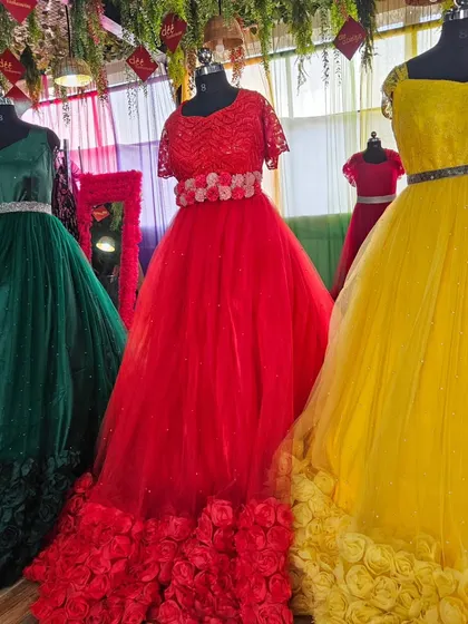 Three beautiful variations of our rose-hem ball gowns in green, red, and yellow. These are perfect for clients who want a classic, fairytale look.