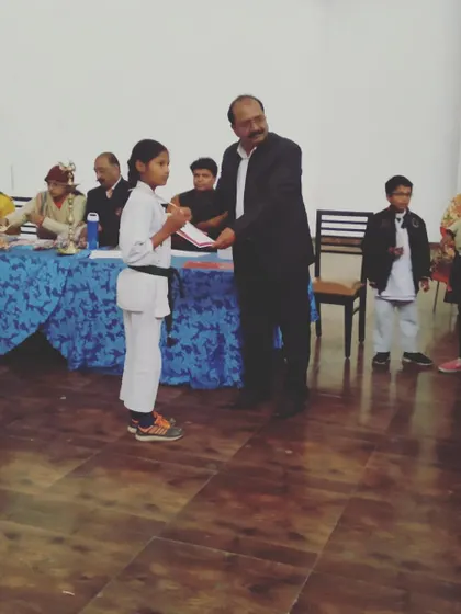 Our head instructor, Mr. Ramesh Bansal, awarding a gold medal to a young champion. We believe in recognizing and celebrating every student's hard-earned success.