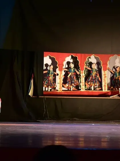The performance captures the subtle emotions of the characters, both human and puppet. This scene highlights the expressive potential of combining live dance with the intricate movements of string puppetry.